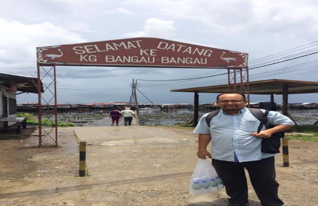 Photograph 2: Main researcher at the entrance of Kampung Bangau-Bangau