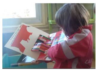Fig. 1. A three-year-old girl supporting Kveta Pacovska’s La Merienda as ateacher, although she wanted to read it on her own. 