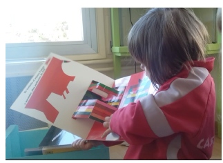 Fig. 1. A three-year-old girl supporting Kveta Pacovska’s La Merienda as ateacher, although she wanted to read it on her own.